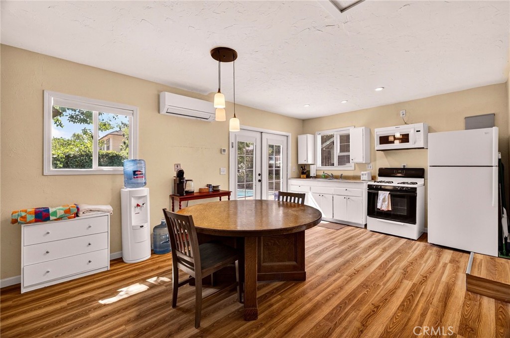 1050 Esplanade Chico, CA 95926 - Photo 35 of 42 a kitchen with stainless steel appliances kitchen island granite countertop a table chairs and a refrigerator