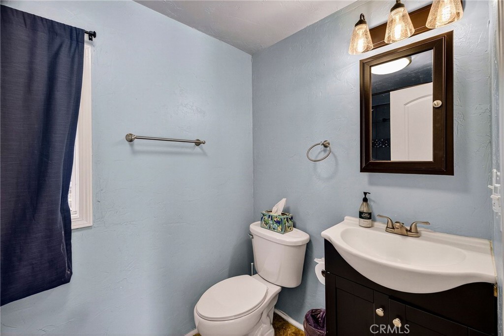 1050 Esplanade Chico, CA 95926 - Photo 37 of 42 a bathroom with a toilet a sink and mirror