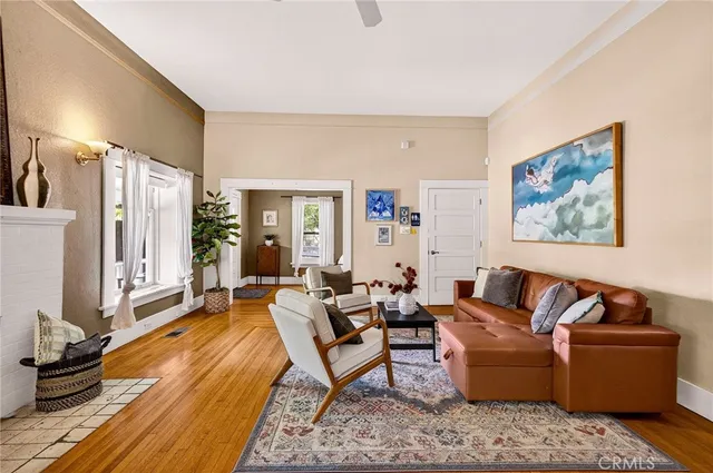 a living room with furniture wooden floor and a large window