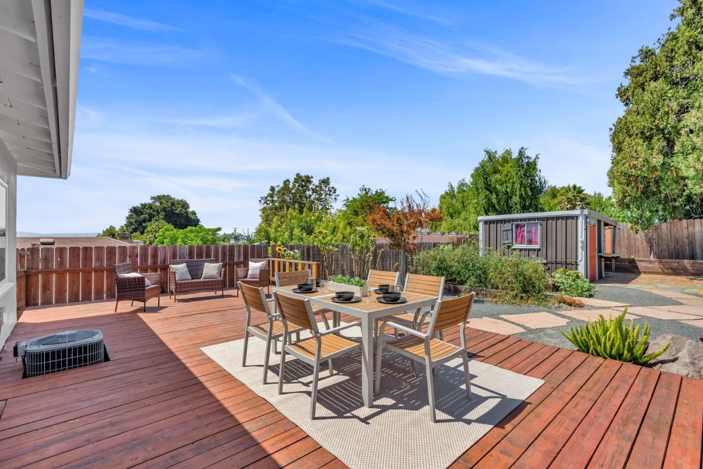 a view of a patio with table and chairs potted plants with wooden floor