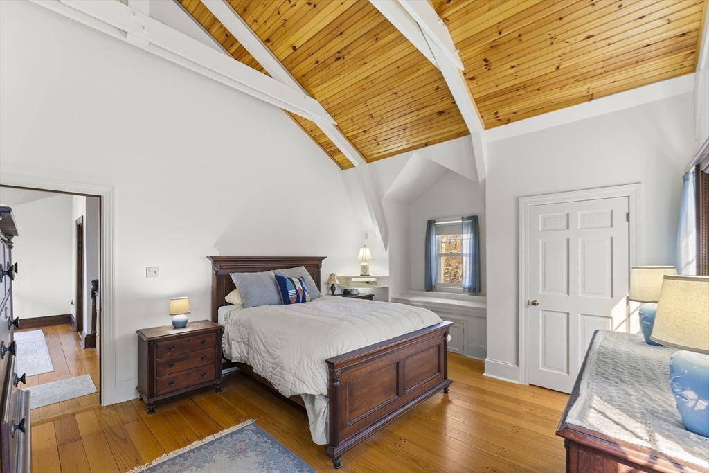 55 Boyles Street Beverly, MA 01915 - Photo 21 of 30 a bedroom with a bed and wooden floor