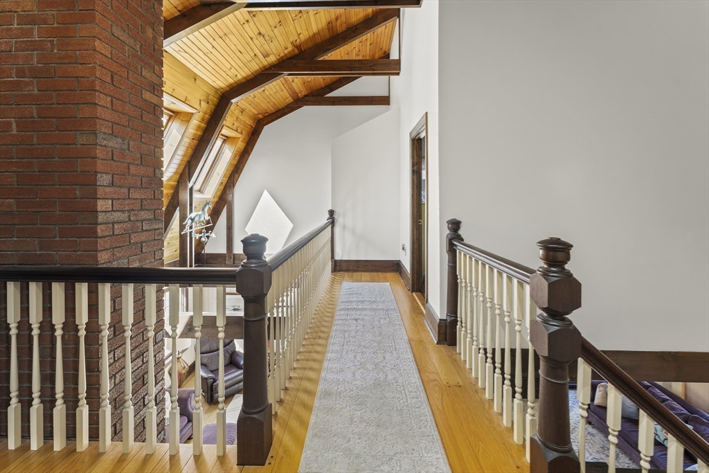 55 Boyles Street Beverly, MA 01915 - Photo 24 of 30 a view of staircase with railing and a painting on the wall