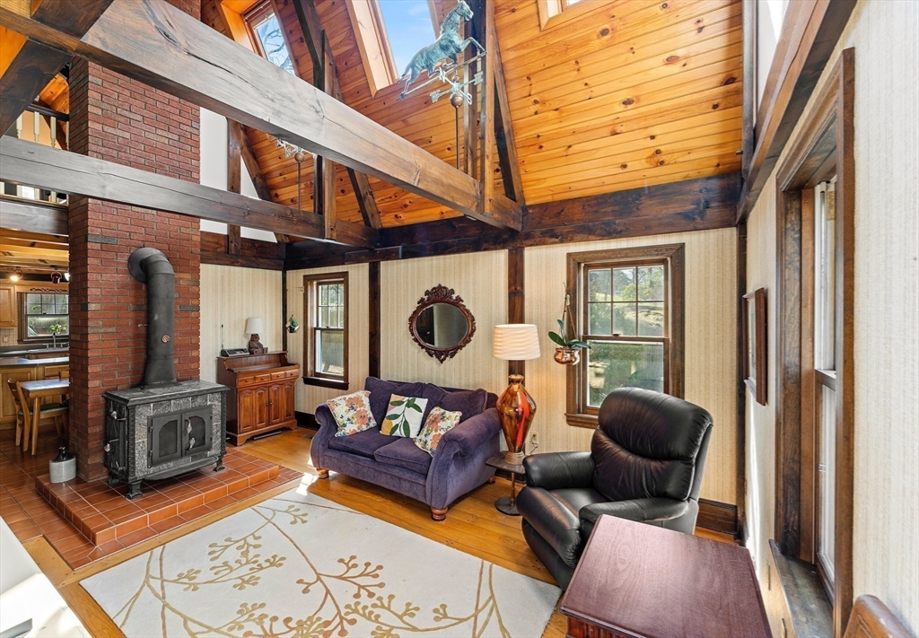 55 Boyles Street Beverly, MA 01915 - Photo 10 of 30 a living room with furniture a fireplace and a large window
