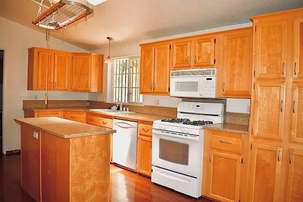 a kitchen with a stove top oven sink and window