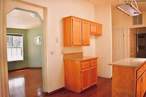 a kitchen with stainless steel appliances granite countertop a refrigerator and a stove