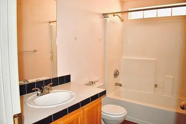 a bathroom with a sink a toilet and a mirror