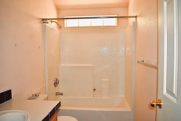a bathroom with a tub and a shower