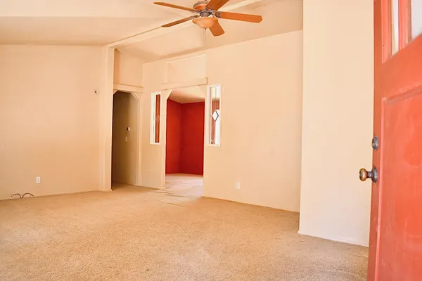 a view of a room with a ceiling fan