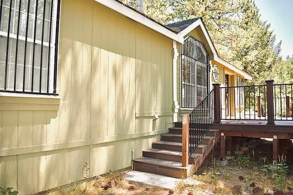 a view of a porch with wooden floor and fence