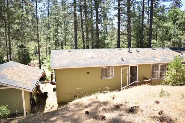 a view of house with a yard and sitting area