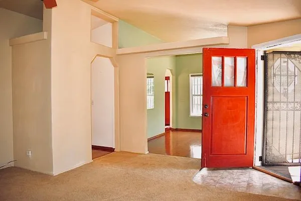 a view of front door with a red door and shower