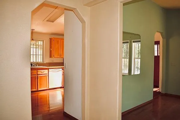 hallway with wooden door and wooden floor