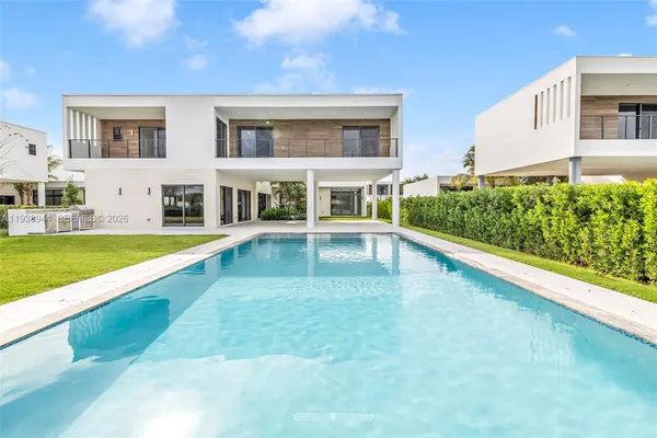 a view of a house with swimming pool and yard