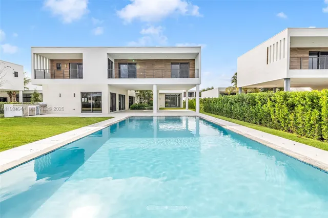 a view of a house with swimming pool and yard
