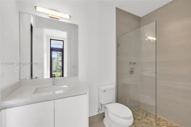 a view of an empty room with wooden floor and a floor to ceiling window