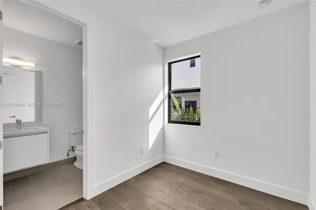 a kitchen with granite countertop a stove and a wooden floors