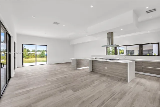 a view of a kitchen with furniture and a large window