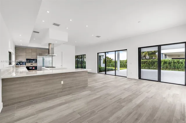 a view of swimming pool with a garden and plants