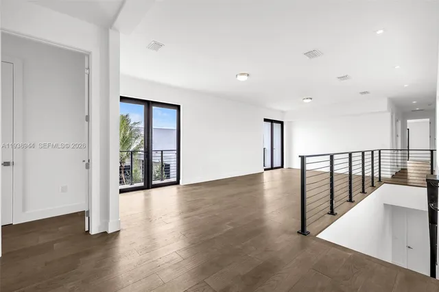a view of a balcony with wooden floor and city view