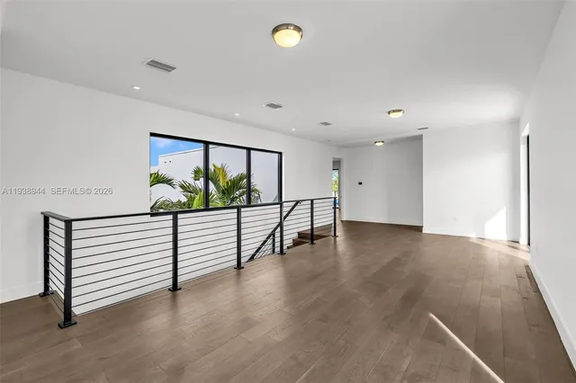 a view of a balcony next to a yard