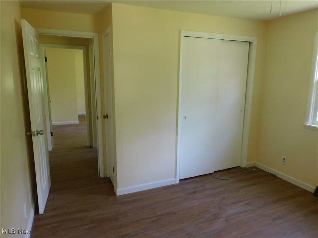 339 Johnson Plank Road Warren, OH 44481 - Photo 20 of 29 bedroom 1 B with dark wood finished floors, a closet, and baseboards