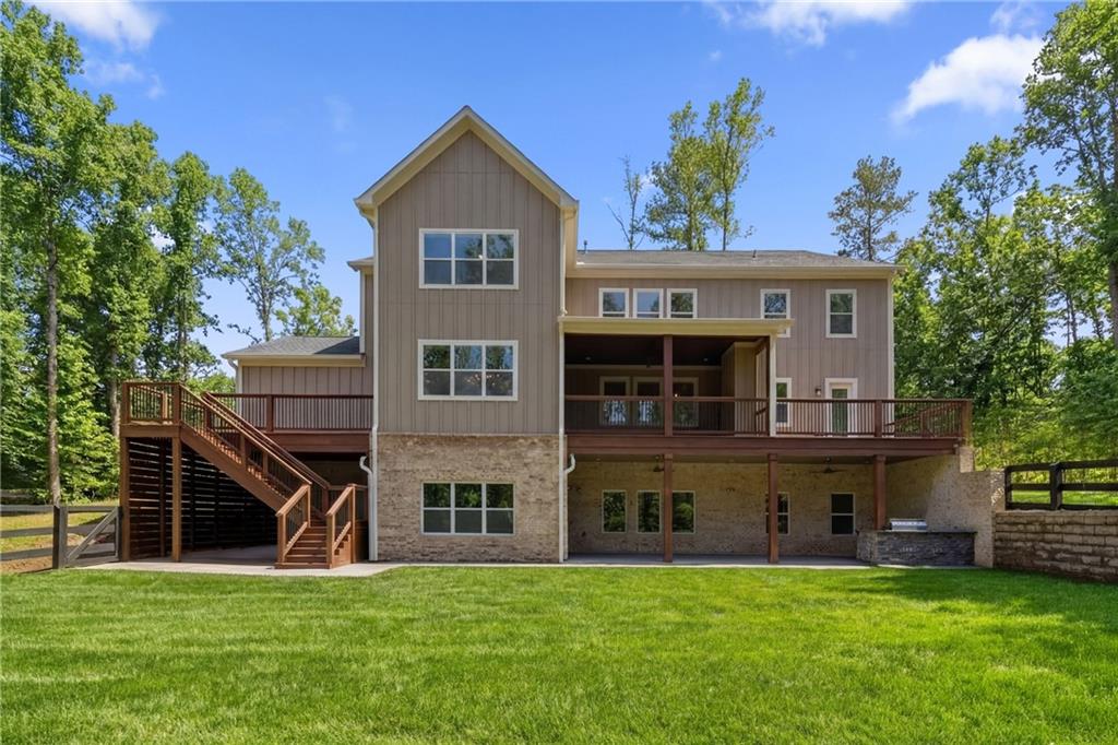 15448 Hopewell Road Milton, GA 30004 - Photo 102 of 125 a view of a big house with a big yard and large trees