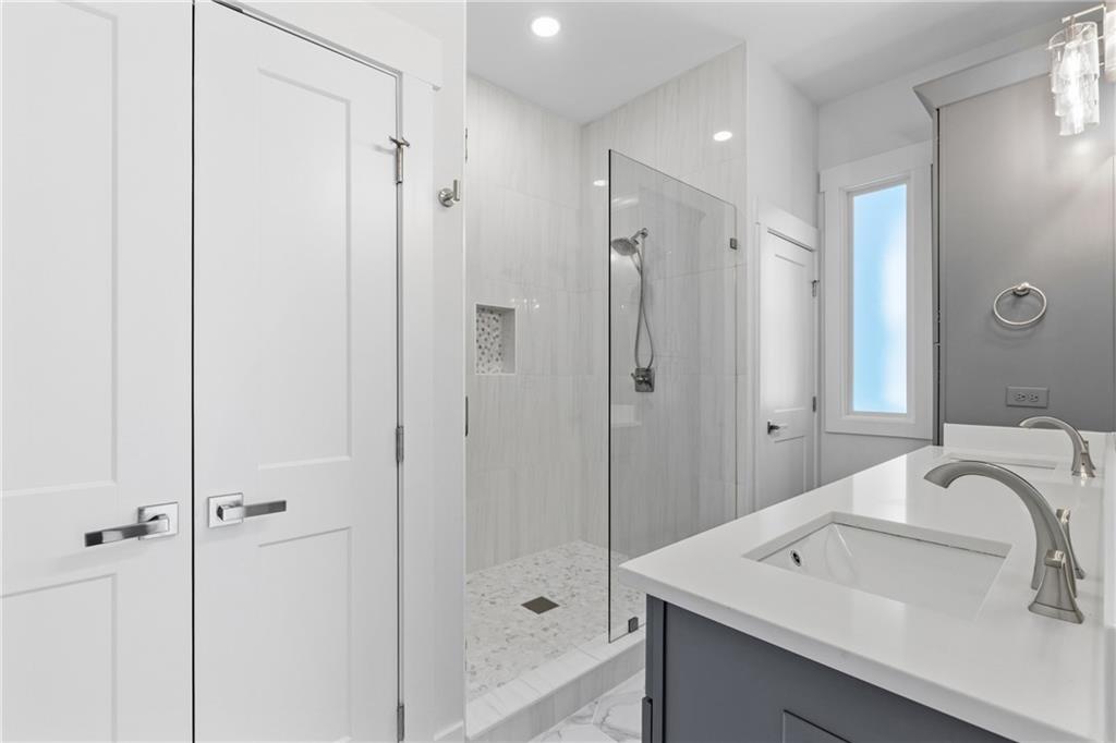 15448 Hopewell Road Milton, GA 30004 - Photo 36 of 125 a bathroom with a sink and a mirror
