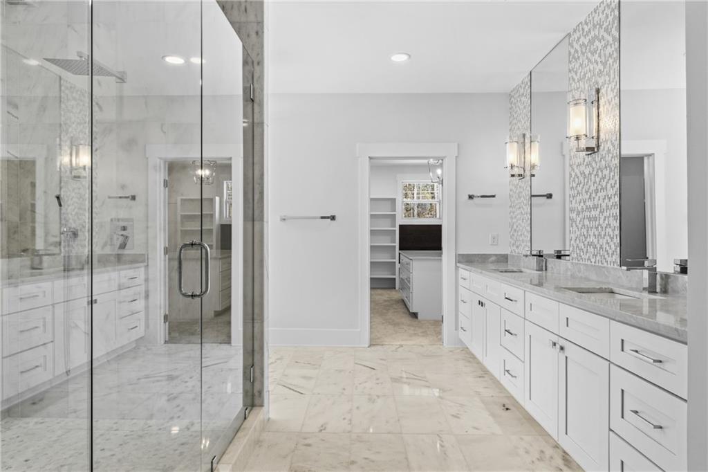 15448 Hopewell Road Milton, GA 30004 - Photo 45 of 125 a bathroom with a granite countertop sink mirror and shower