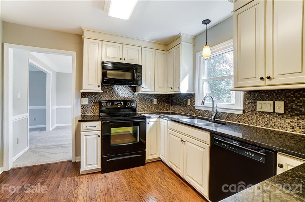 10101 Deer Spring Lane Charlotte, NC 28210 - Photo 13 of 45 a kitchen with stainless steel appliances granite countertop a stove a sink and a microwave