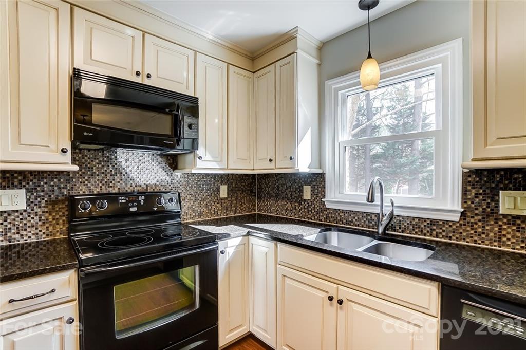10101 Deer Spring Lane Charlotte, NC 28210 - Photo 15 of 45 a kitchen with a stove and a microwave