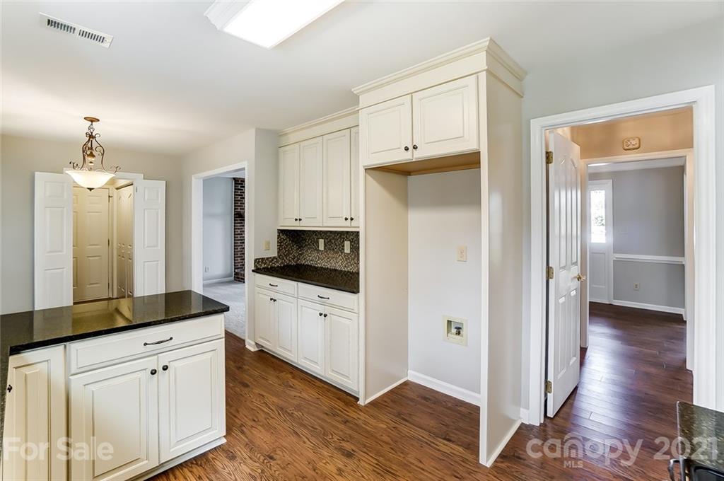 10101 Deer Spring Lane Charlotte, NC 28210 - Photo 16 of 45 a kitchen with white cabinets and stainless steel appliances