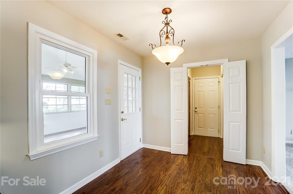 10101 Deer Spring Lane Charlotte, NC 28210 - Photo 18 of 45 a view of a room with wooden floor and chandelier
