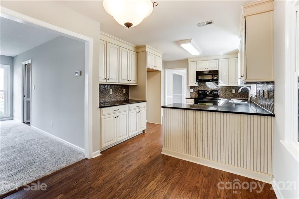 10101 Deer Spring Lane Charlotte, NC 28210 - Photo 20 of 45 a kitchen with granite countertop a sink cabinets and wooden floor