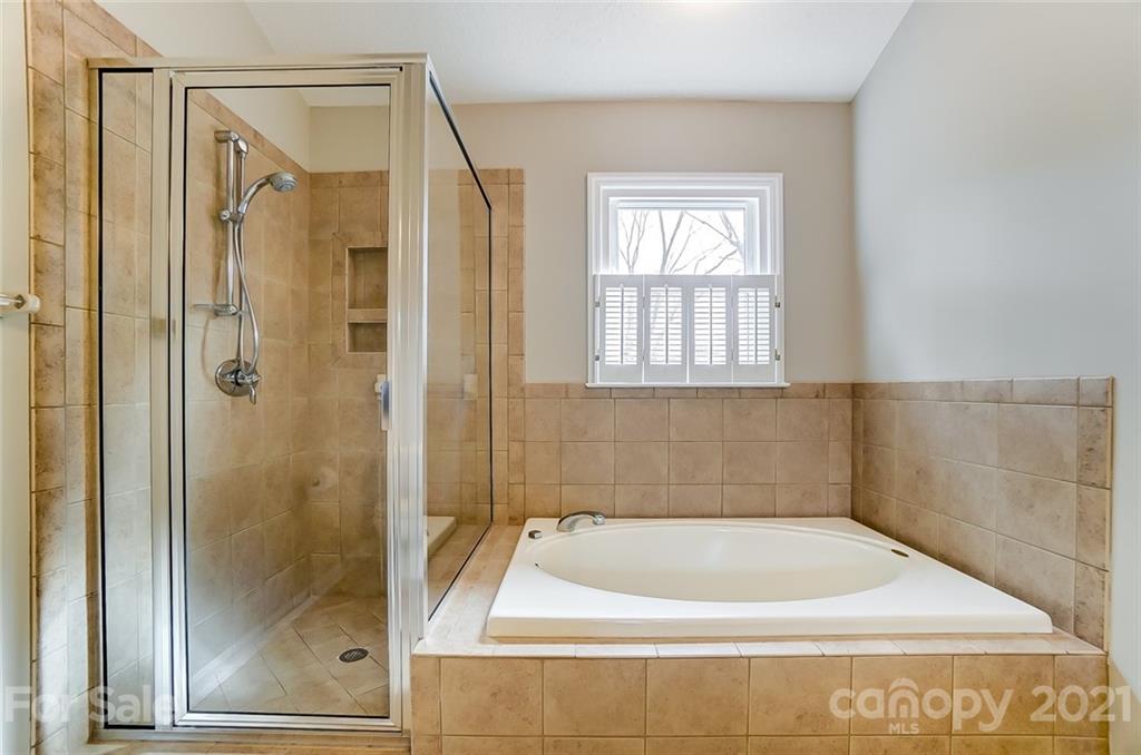 10101 Deer Spring Lane Charlotte, NC 28210 - Photo 28 of 45 a bath tub sitting next to a shower