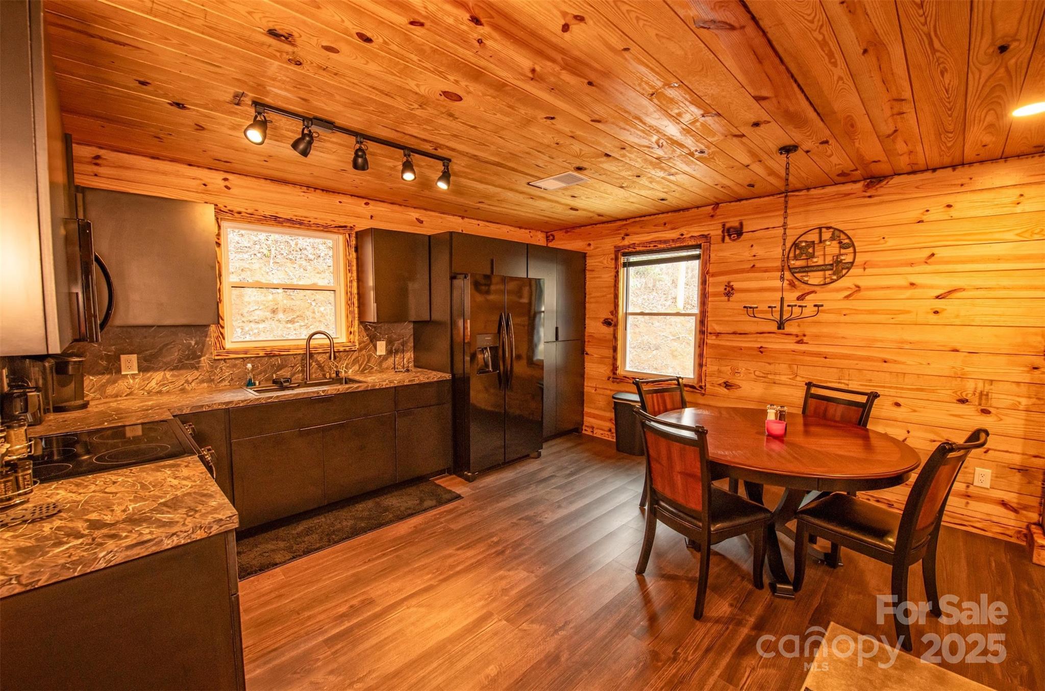 23 Honeysuckle Ridge Almond, NC 28702 - Photo 11 of 21 a view of a dining room with furniture and wooden floor