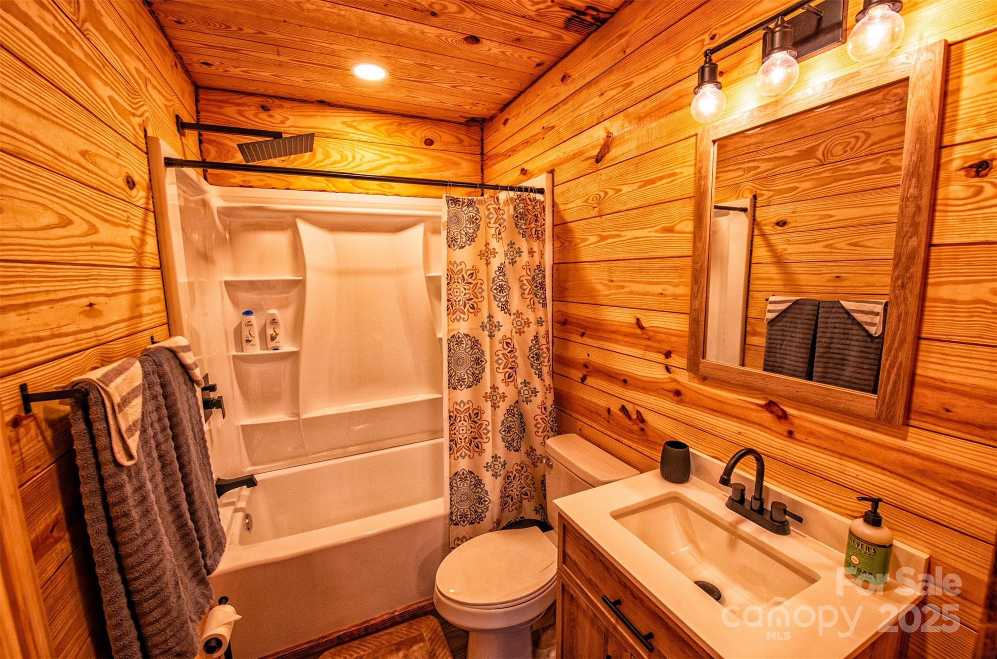 23 Honeysuckle Ridge Almond, NC 28702 - Photo 20 of 21 a bathroom with a sink toilet and shower