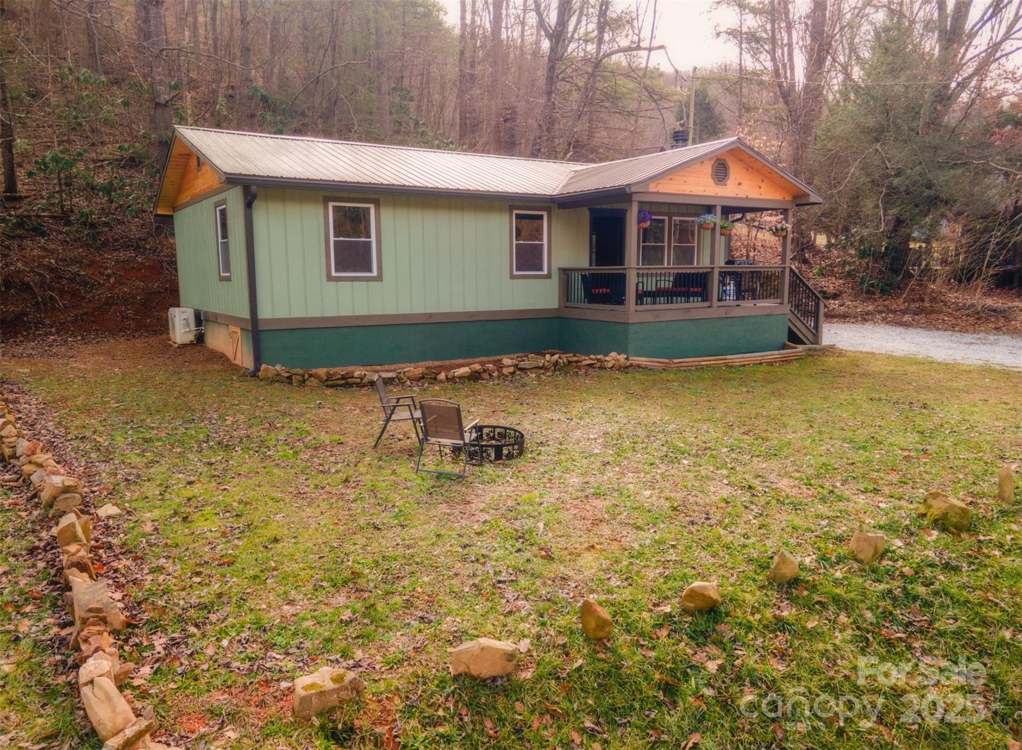 23 Honeysuckle Ridge Almond, NC 28702 - Photo 5 of 21 a backyard of a house with table and chairs