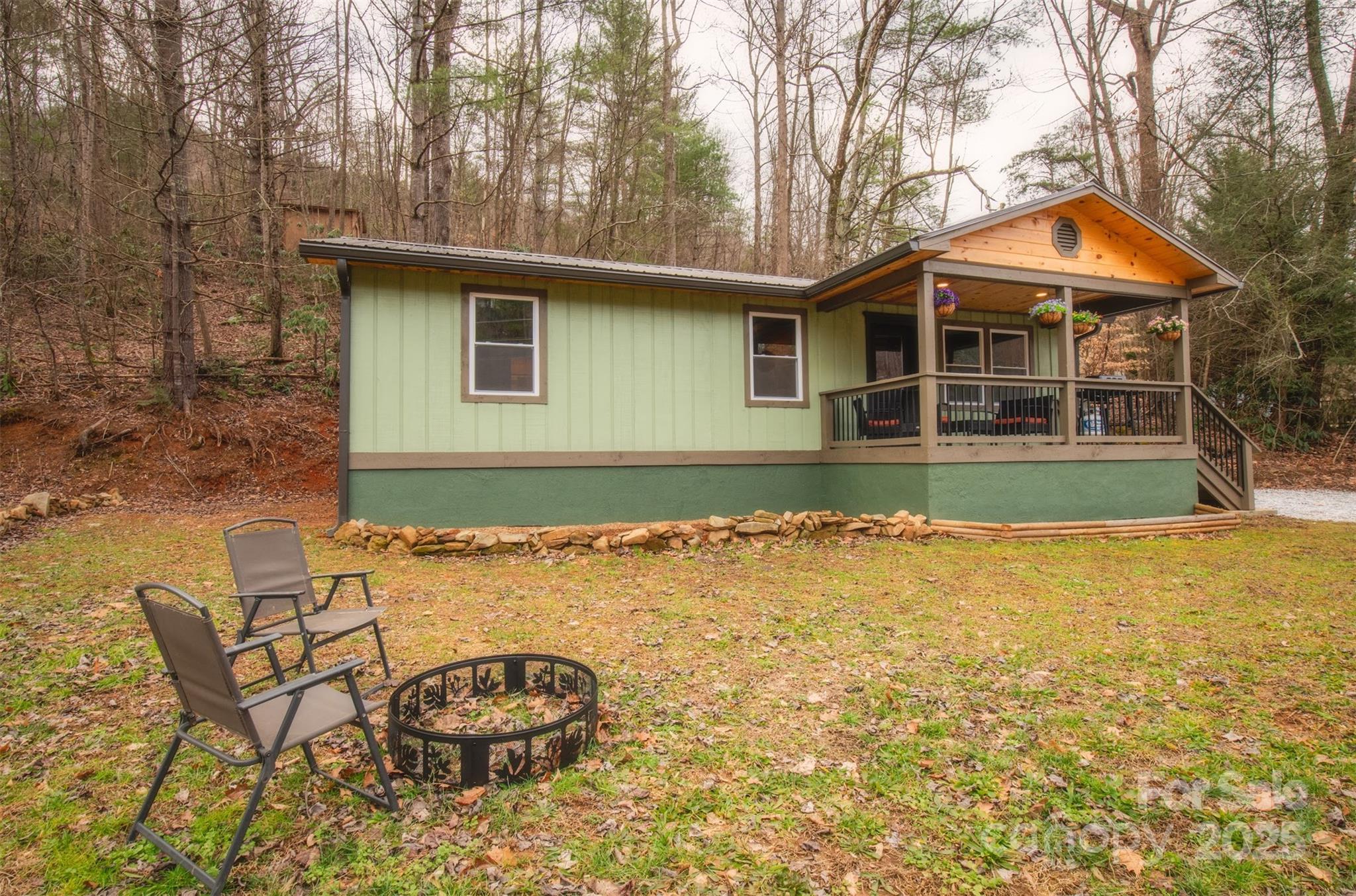 23 Honeysuckle Ridge Almond, NC 28702 - Photo 7 of 21 a backyard of a house with barbeque oven table and chairs