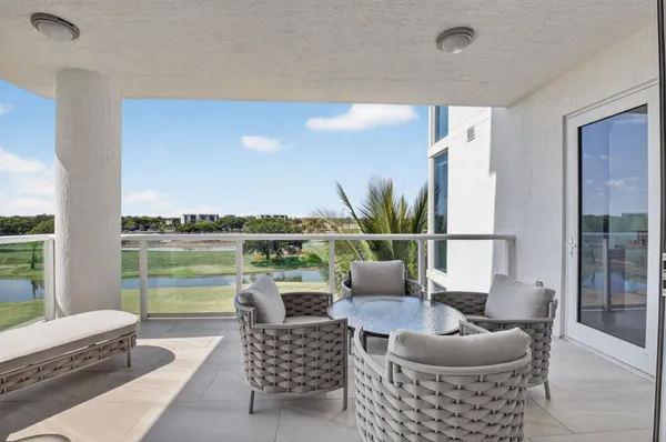 a view of a house with swimming pool and sitting area