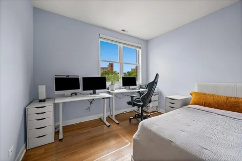 a bed sitting in a bedroom next to a window