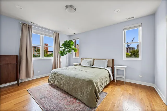 a bedroom with a bed and a plant