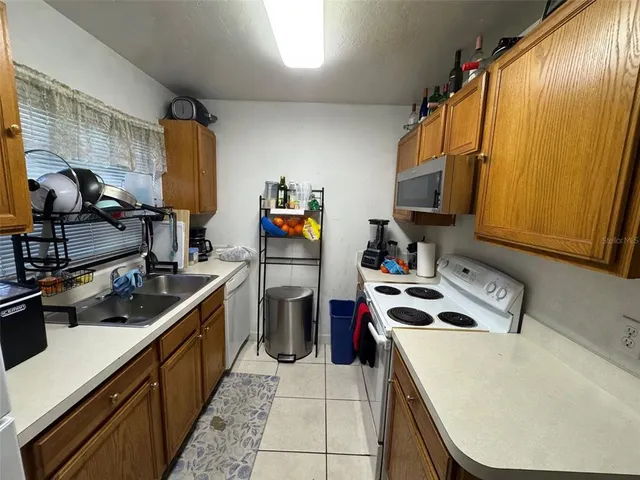 a kitchen that has a sink and a stove in it