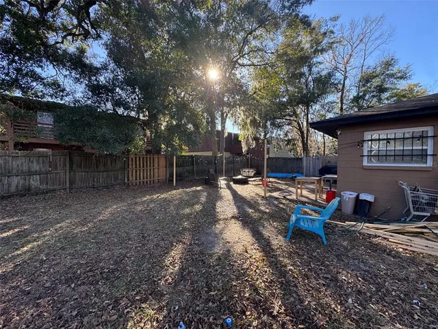 a backyard of a house with table and chairs