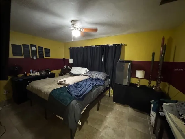 a bedroom with a bed and lamp