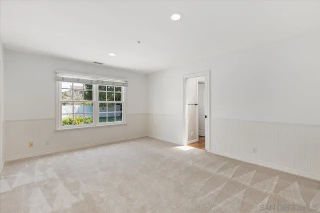 a view of a patio with table and chairs with wooden floor and fence