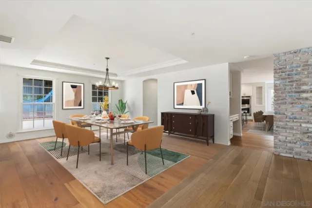 a living room with furniture a wooden floor and a chandelier