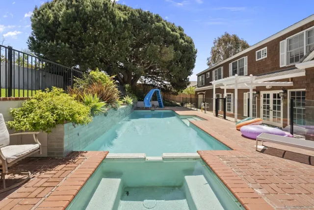 a view of a house with a yard and sitting area