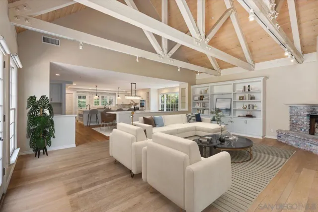 a living room with furniture wooden floor and a large window