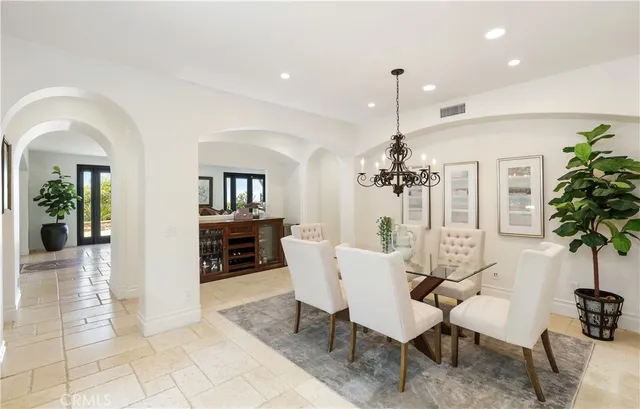 a very nice looking open dining room with kitchen island furniture a large window and kitchen view