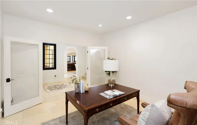 a spacious bedroom with a large bed and a chandelier